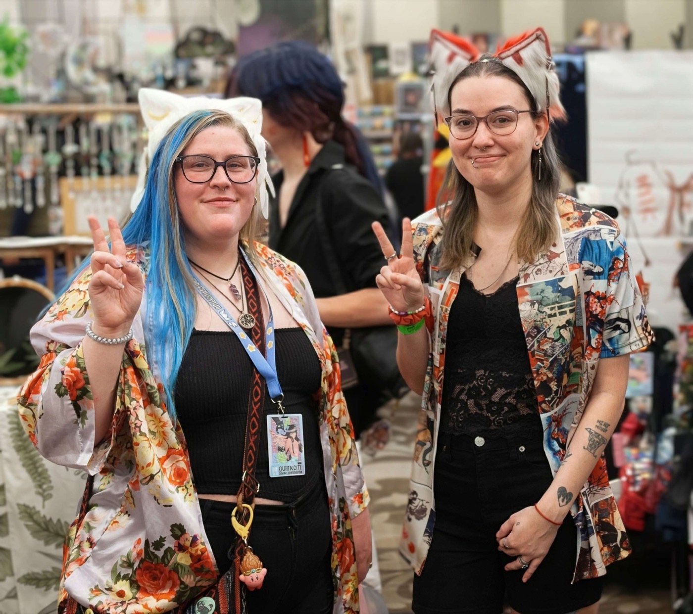 Artists posing in the Queen City Anime Con vendor hall