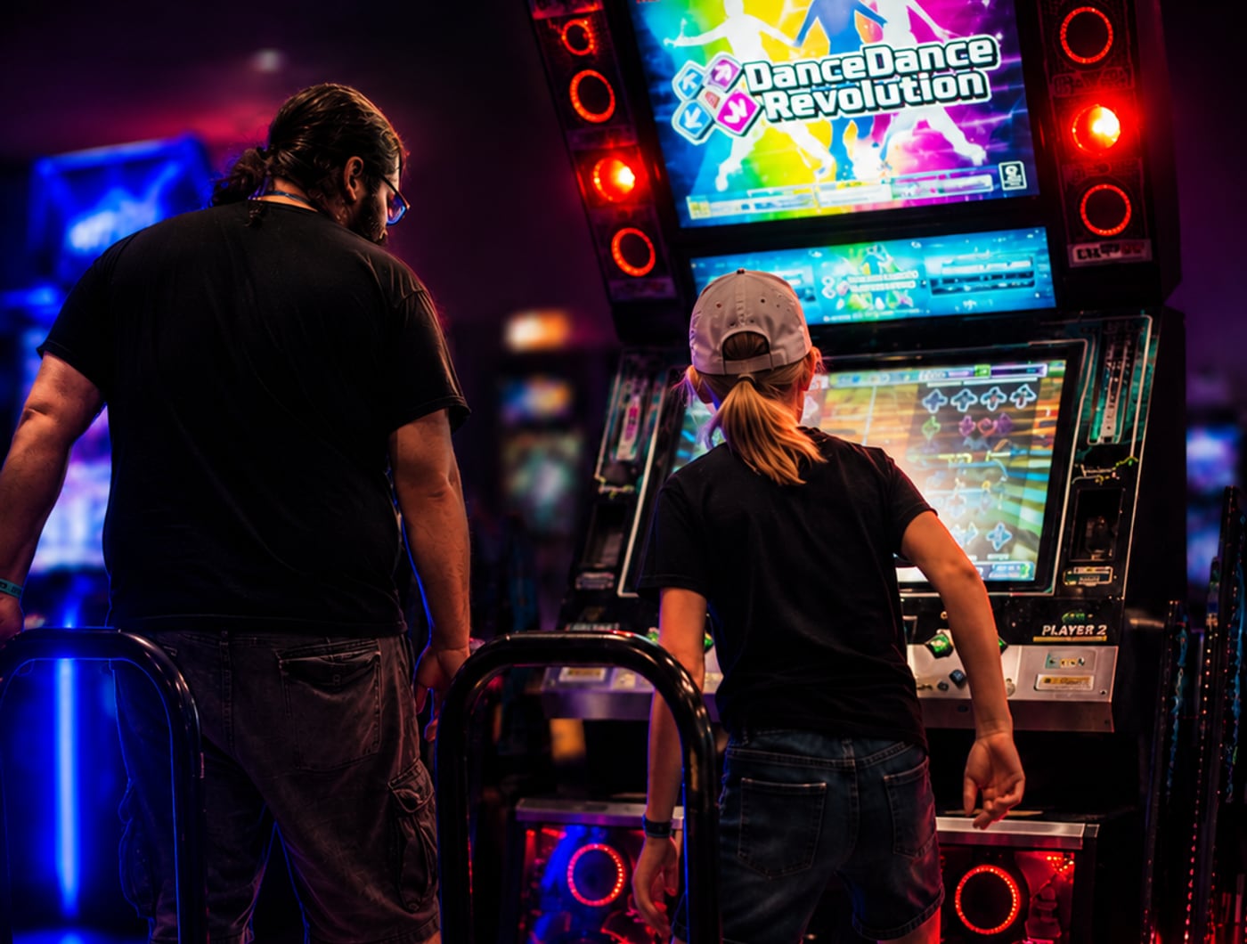 Attendees playing Dance Dance Revolution at Queen City Anime Con
